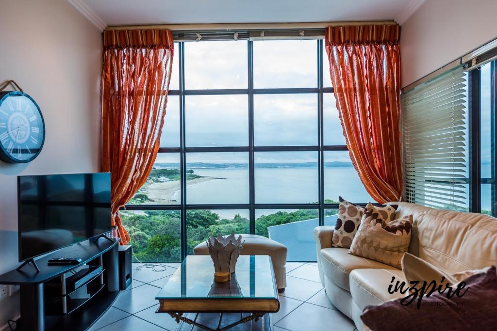 a living room with a couch and a large window at Gouriqua 401 in Mossel Bay