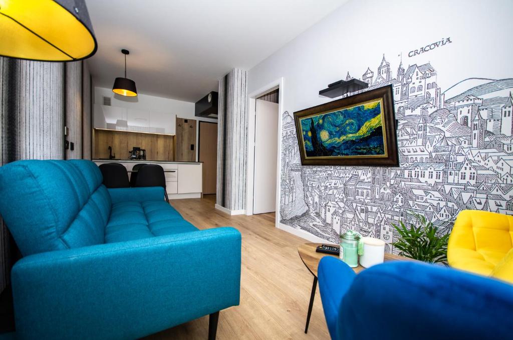 a living room with a blue couch and a drawing on the wall at InPoint Apartments G15 near Old Town & Kazimierz in Kraków