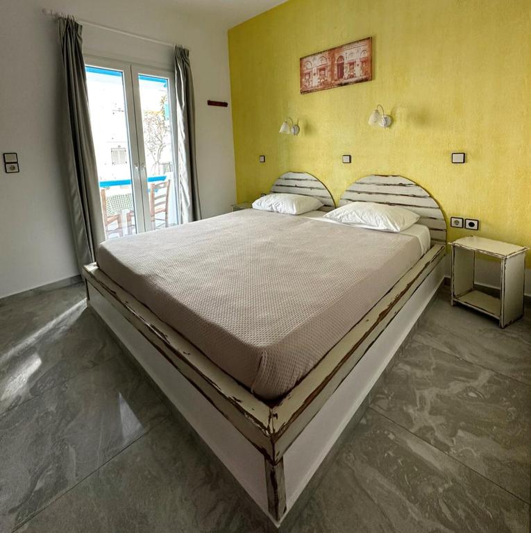 a large bed in a room with a window at Studios Matina in Naxos Chora