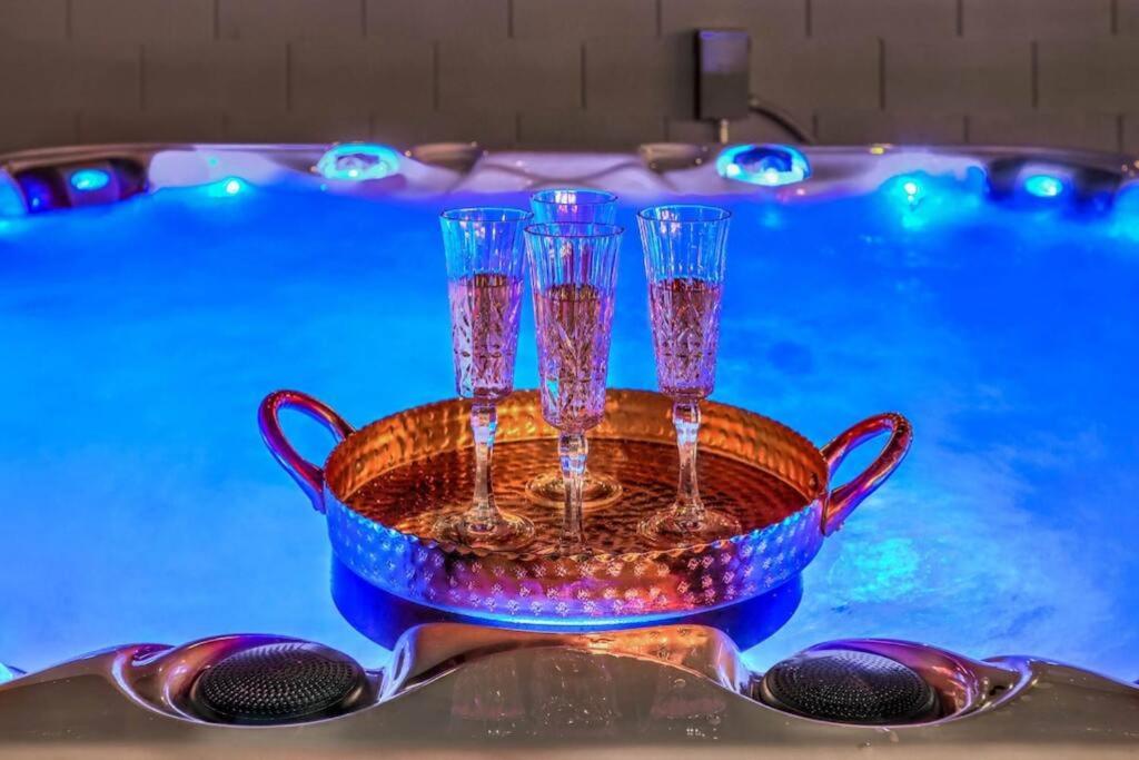 a tray with four wine glasses on top of a swimming pool at Chateau Desert Oasis minutes from Vegas Strip in Las Vegas
