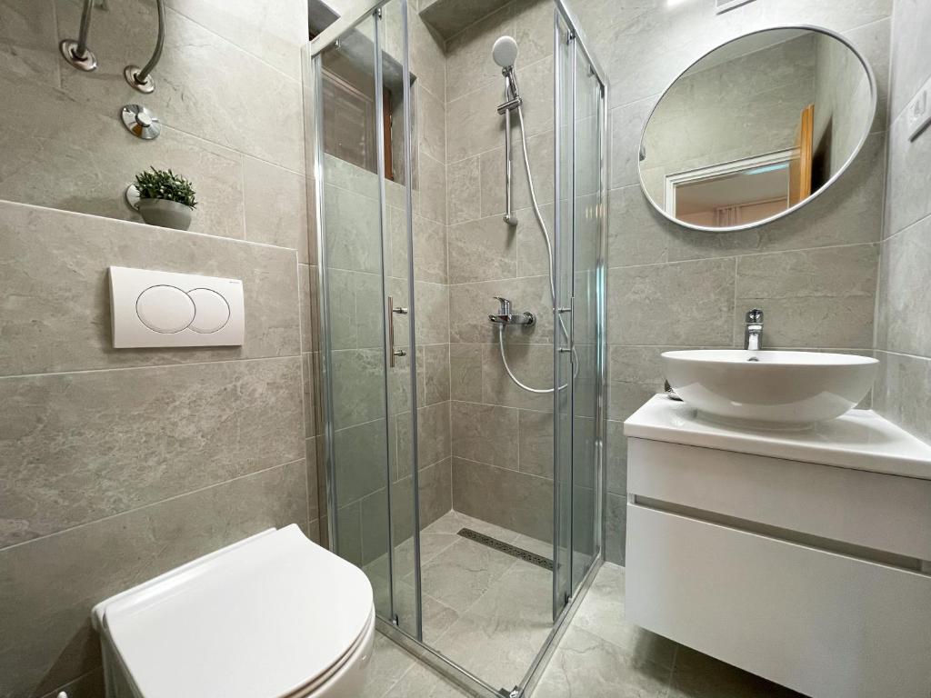 a bathroom with a shower and a toilet and a sink at Apartments Marija Magdalena in Hvar