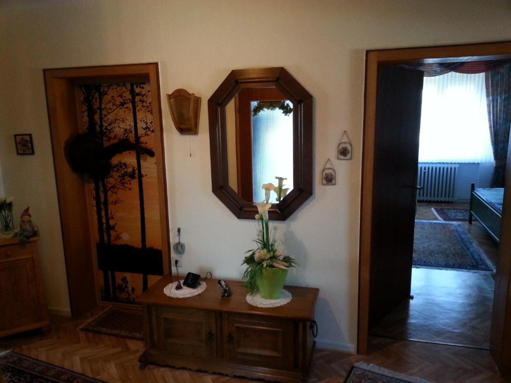 a living room with a mirror and a table at Hainbuche in Schauenburg