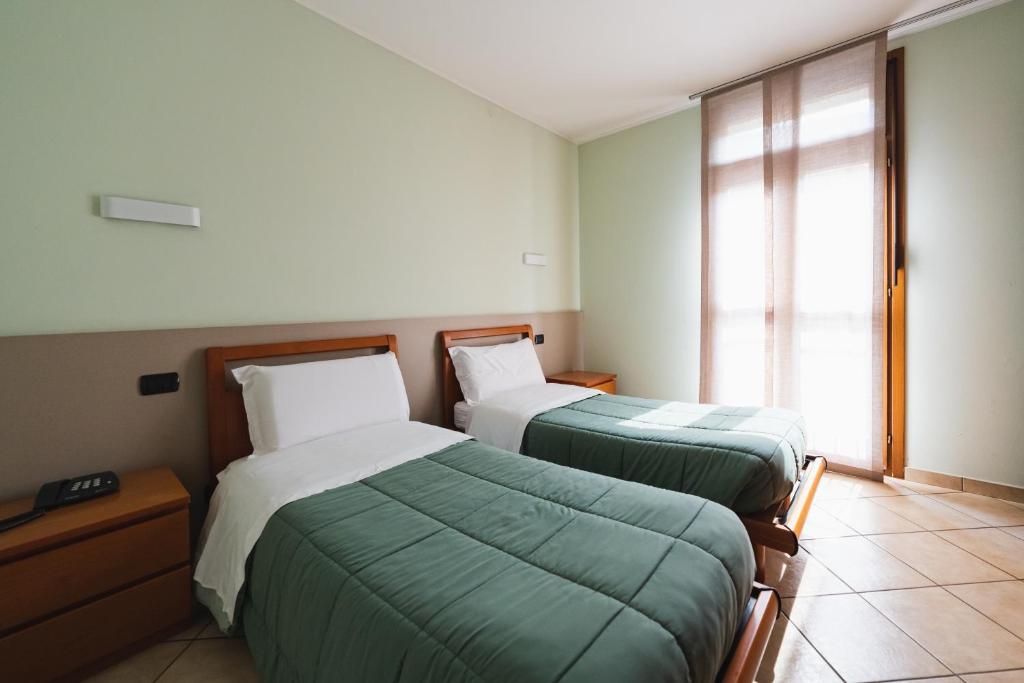 Postel nebo postele na pokoji v ubytování Parini Hotel