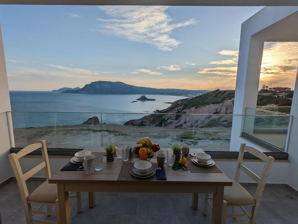 a dining room table with a view of the ocean at Cute apartments in Kefalos