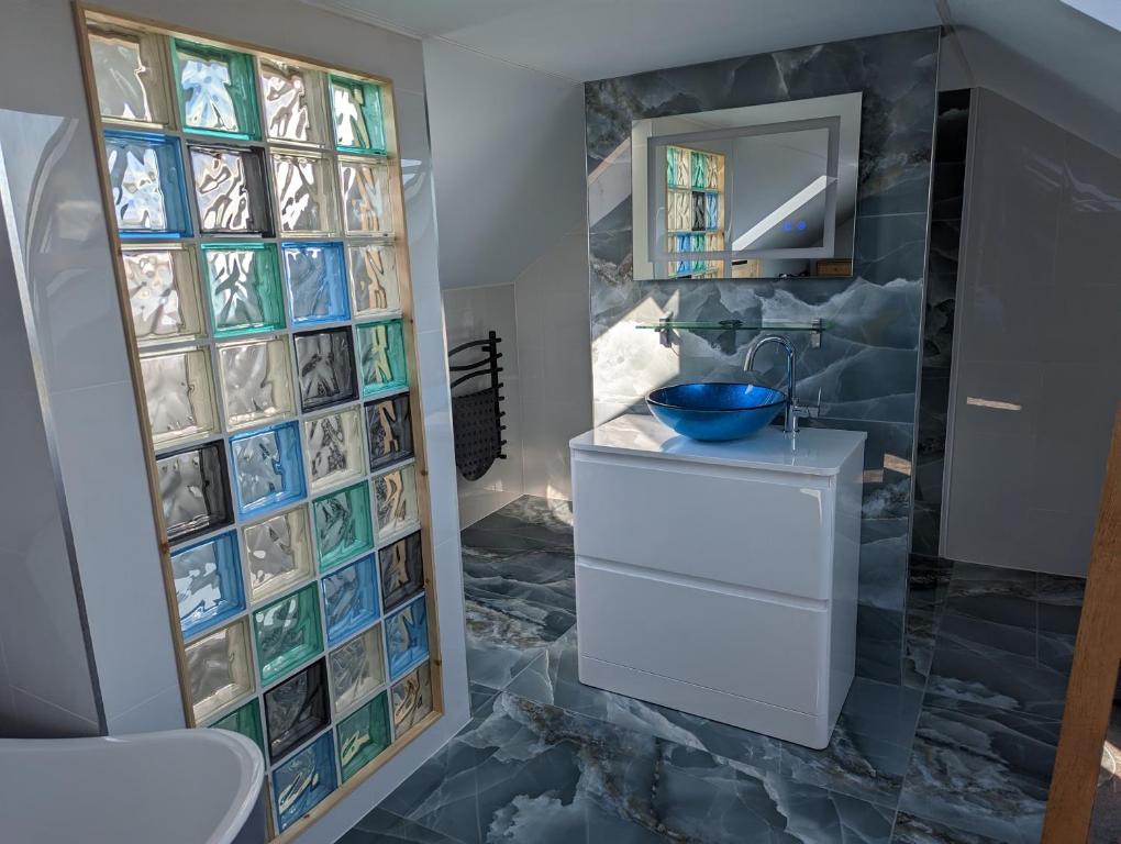 La salle de bains est pourvue d'un lavabo et d'un miroir. dans l'établissement Seals Bacton, à Bacton