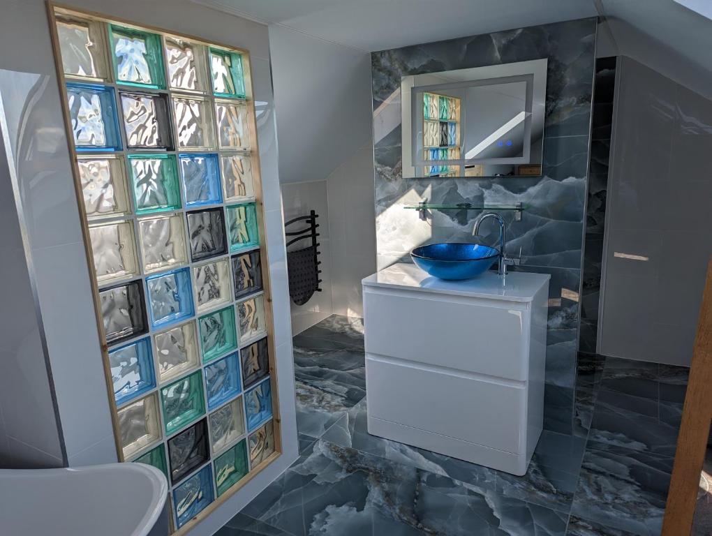 a bathroom with a sink and a mirror at Seals Bacton in Bacton