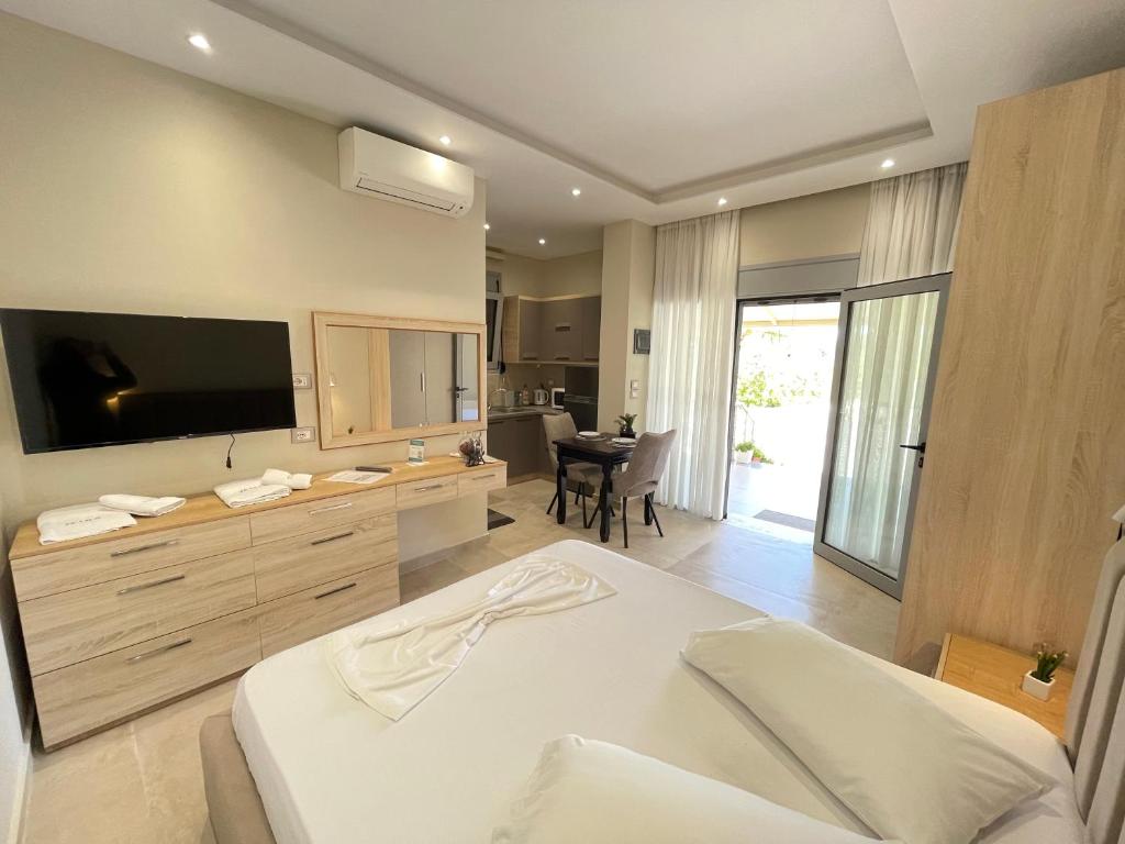 a bedroom with a bed with a television and a table at Anel Studios in Vlorë