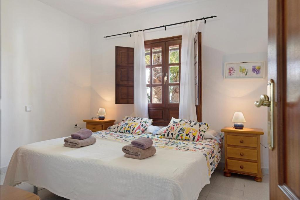 Postel nebo postele na pokoji v ubytování Villa Las Palmeras