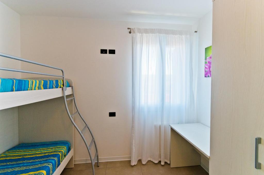 Postel nebo postele na pokoji v ubytování Villa Marina Apartments - Agenzia Cocal