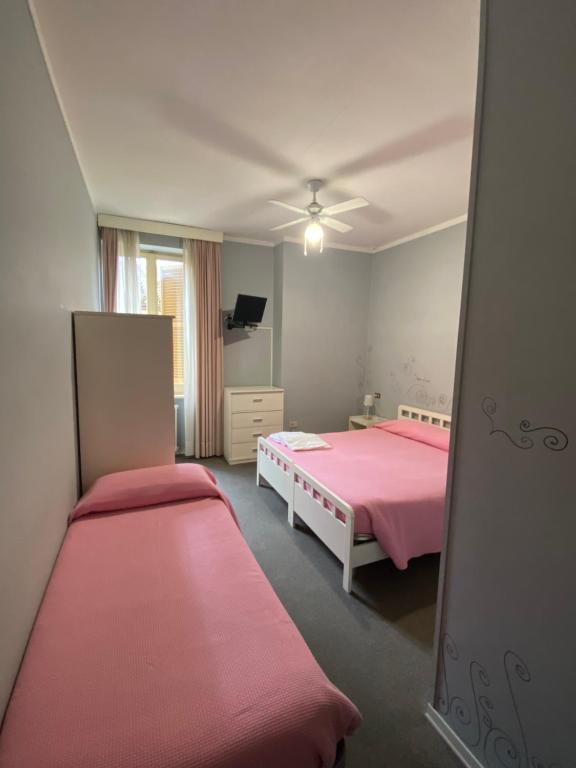 Postel nebo postele na pokoji v ubytování HOTEL LA LOGGIA