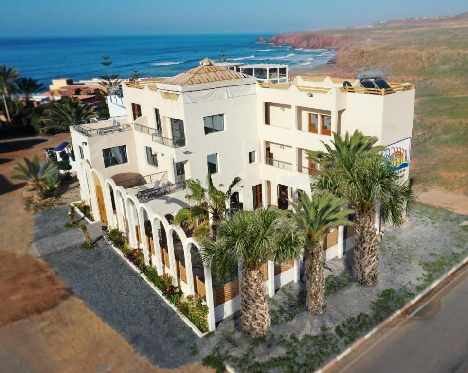 an aerial view of a house with palm trees at Les Bains de Mirleft in Mirleft