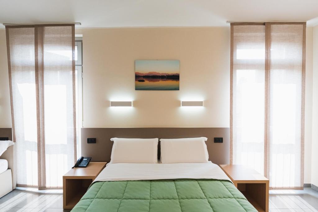 Postel nebo postele na pokoji v ubytování Parini Hotel
