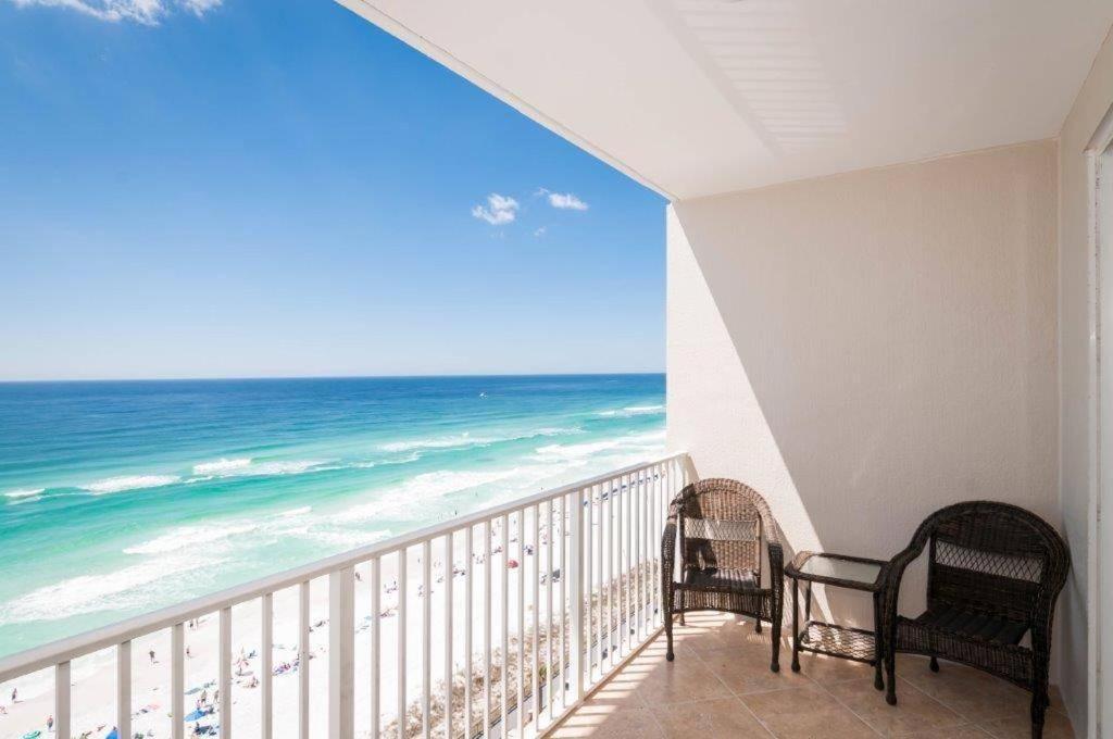 a balcony with two chairs and a view of the ocean at Majestic Sun 1108B in Destin