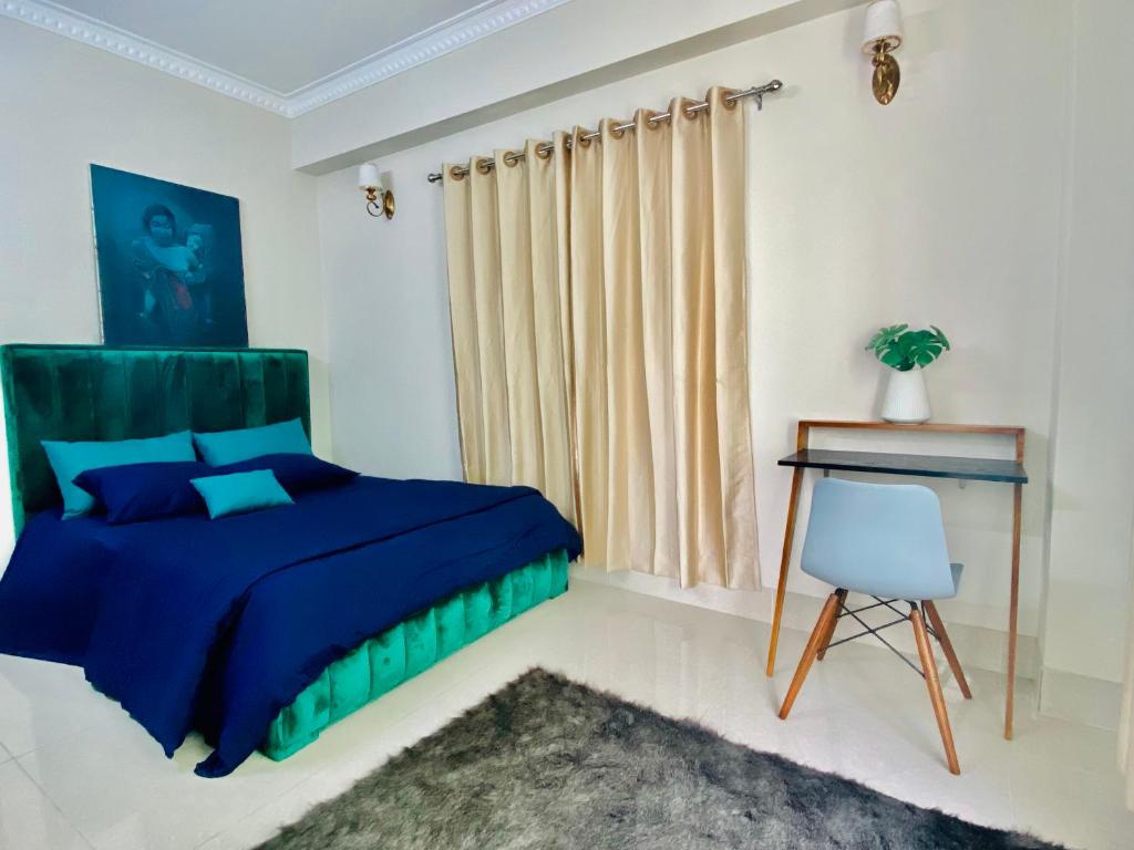 a bedroom with a blue bed and a desk at Private Room near Istanbul Airport 2 in Arnavutköy