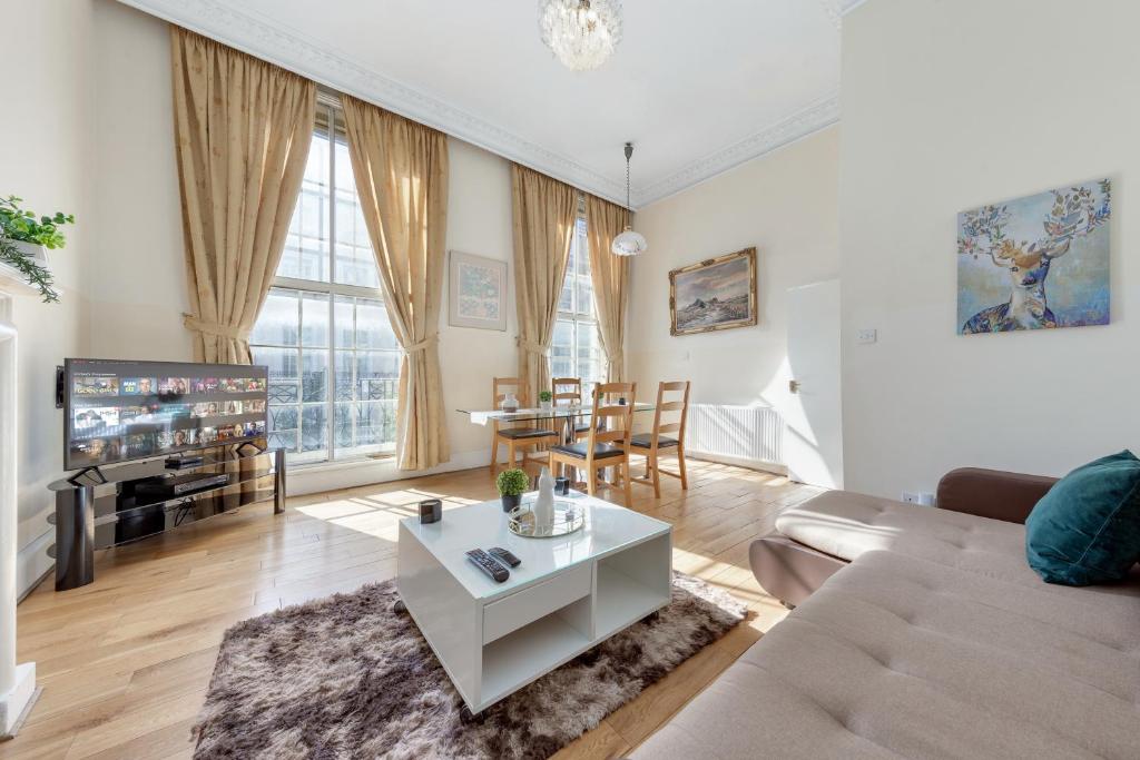 a living room with a couch and a table at Apartment in Baker Street- Huge Balcony in London