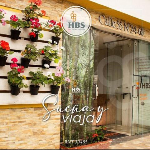 a window of a flower shop with potted plants on it at HBS Hotel in Manizales