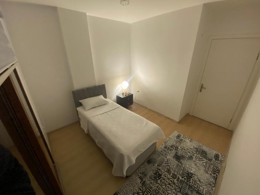 a small room with a bed and a night stand at Dublex villa in Çeşme
