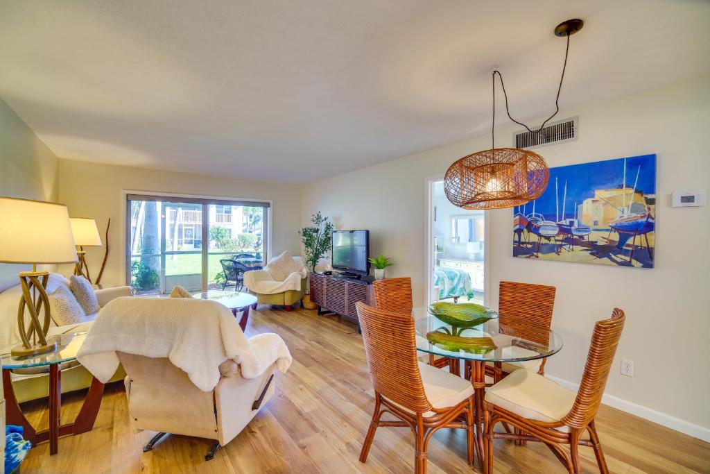 a dining room and living room with a table and chairs at Hutchinson Island Vacation Rental with Beach Access! in Fort Pierce