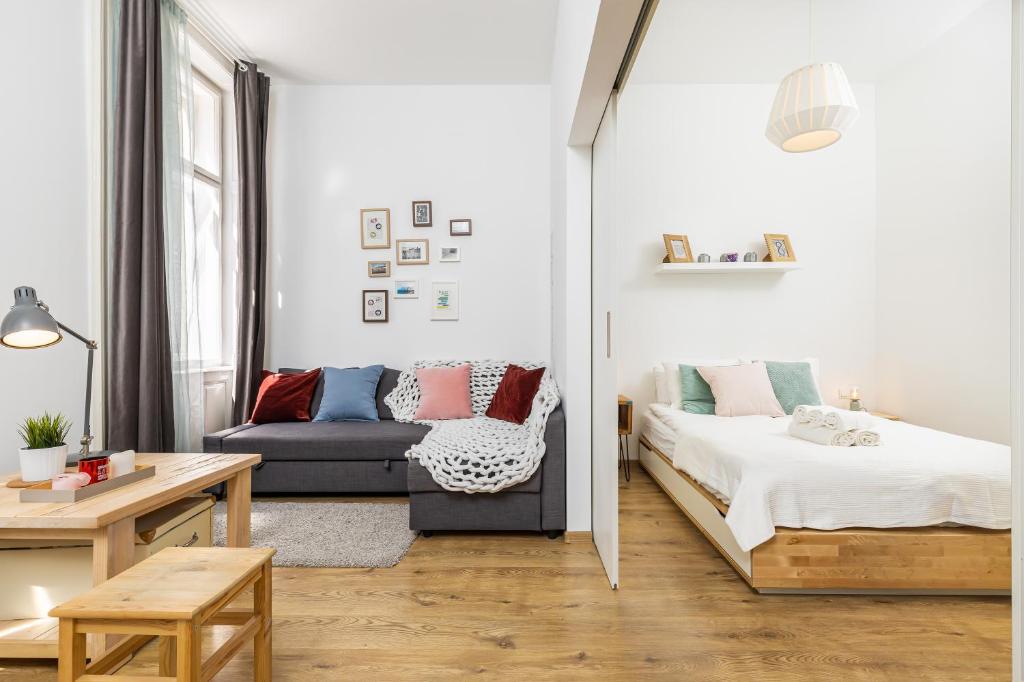 a living room with a bed and a couch at Paco&Orsi's homey cosy apartment in the city center in Budapest