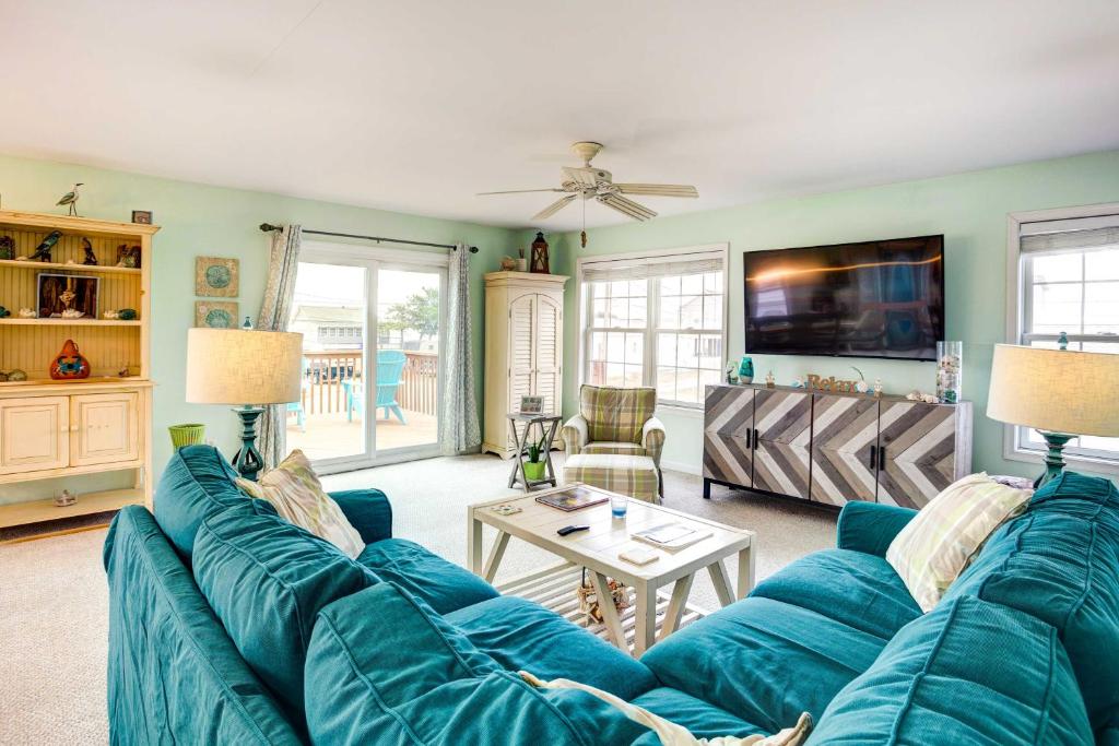 - un salon avec un canapé bleu et une table dans l'établissement Bowers Beach Vacation Rental 2 Blocks Away!, à Frederica