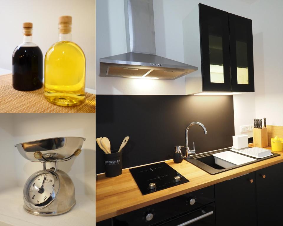 a kitchen with a bottle of oil and a sink at Appartement de charme Art Déco in Vichy