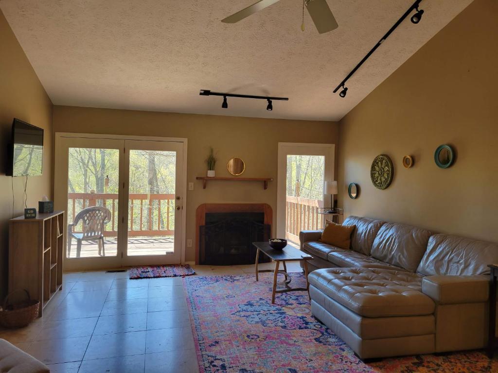 a living room with a couch and a fireplace at Preston Hollow in Bloomington