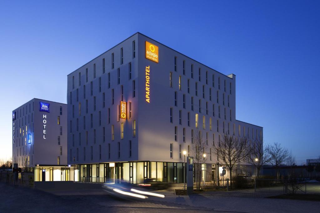 a building with a sign on the side of it at Aparthotel Adagio access München City Olympiapark in Munich
