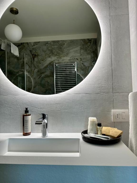a bathroom with a sink and a mirror at C House Rooms Lake in Peschiera del Garda