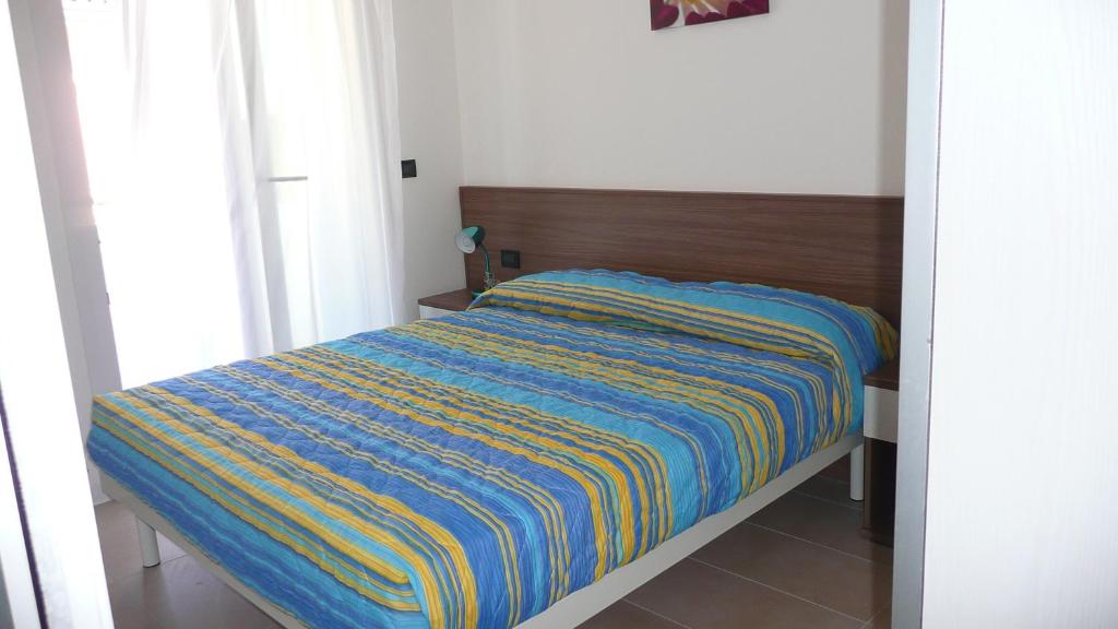 Postel nebo postele na pokoji v ubytování Villa Marina Apartments - Agenzia Cocal