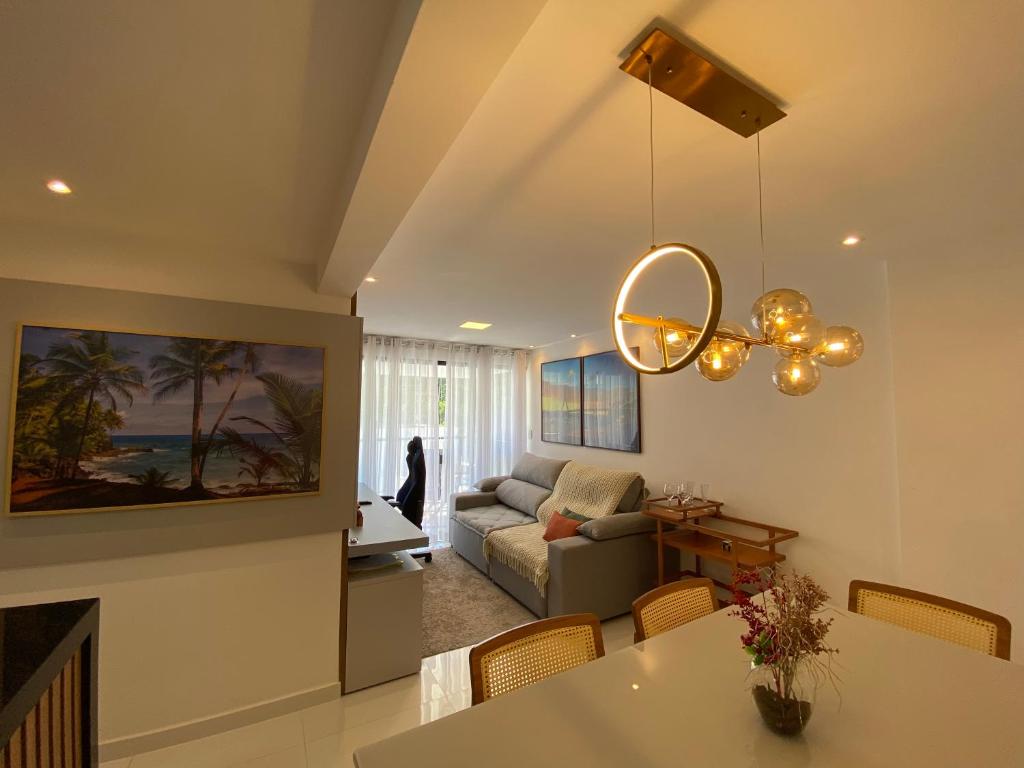 a living room with a couch and a table at Residencial Maranello in Ilhéus