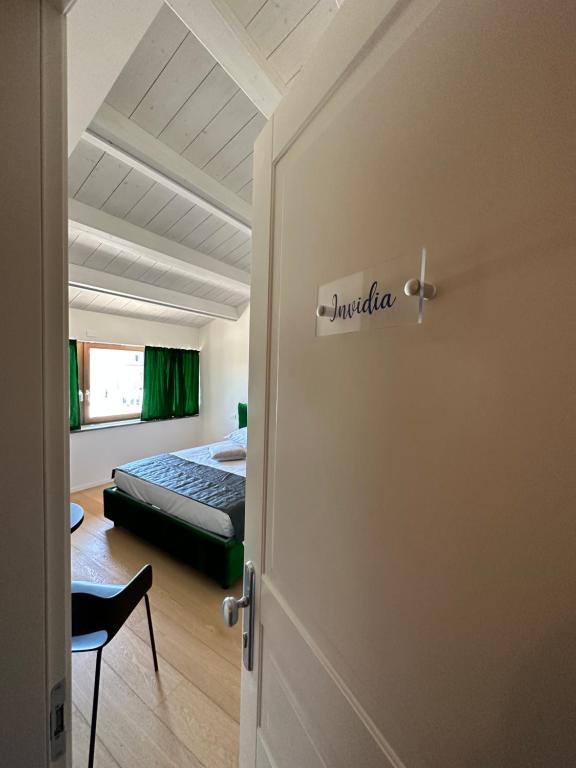 a door to a bedroom with a bed in a room at C House Rooms Lake in Peschiera del Garda