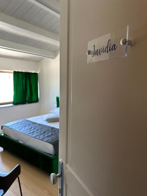 a door to a bedroom with a bed in it at C House Rooms Lake in Peschiera del Garda
