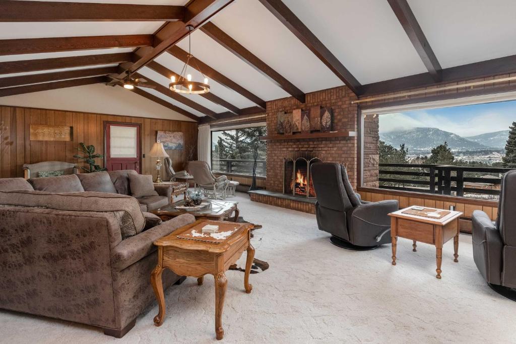 a living room with a couch and a fireplace at Spacious Colorado Retreat with Deck and Mountain Views in Estes Park