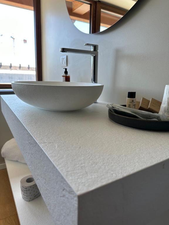 a bathroom with a white bowl sink on a counter at C House Rooms Lake in Peschiera del Garda