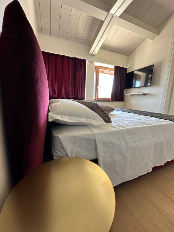 a bedroom with a bed and a table and a chair at C House Rooms Lake in Peschiera del Garda