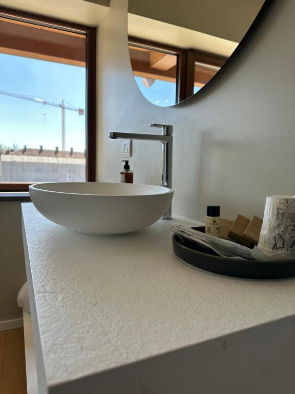 a bathroom with a white bowl sink on a counter at C House Rooms Lake in Peschiera del Garda