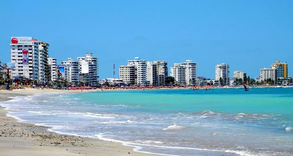 a beach with hotels and buildings in the background at Ecusuites Salinas Resort Aquamira Balcony in Salinas