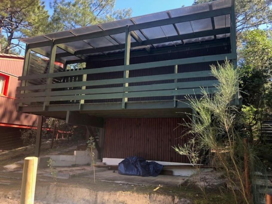 a building with a solarium on top of it at CHALET avec PISCINE proche LAC et OCEAN in Carcans