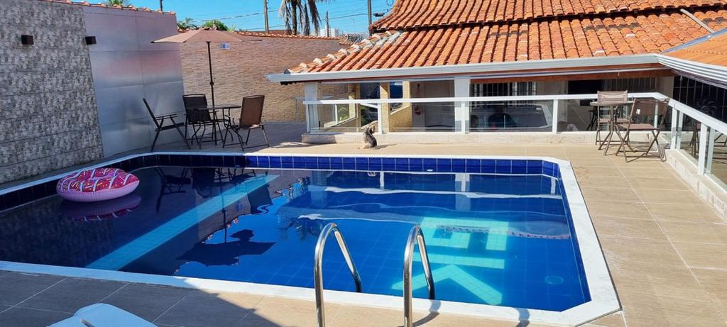 una piscina frente a una casa en Casa com piscina e Wi Fi em Mongagua SP, en Praia Grande