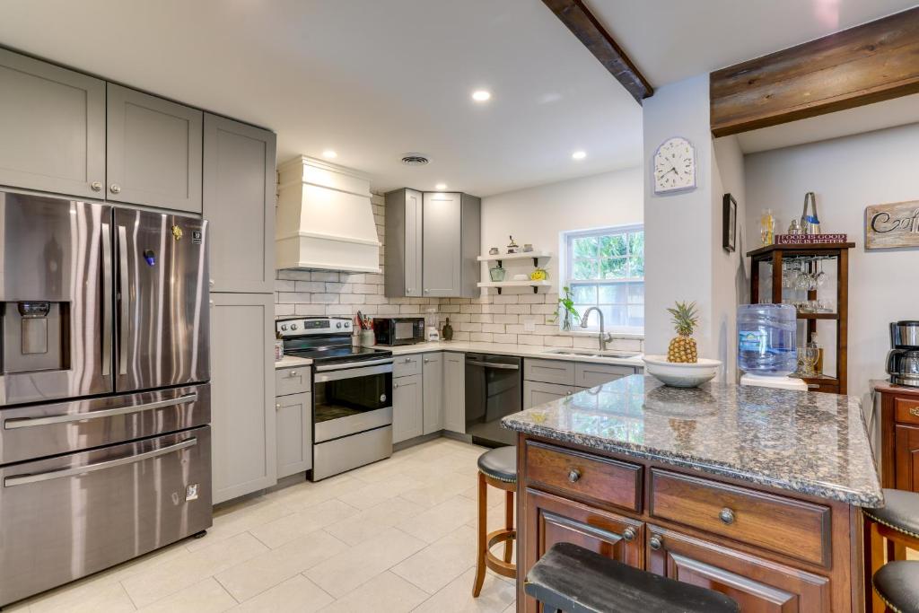 a large kitchen with stainless steel appliances and cabinets at Charming Home with Yard about 5 Mi to Clearwater Beach! in Clearwater