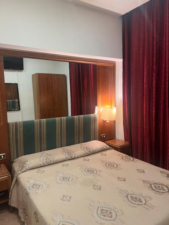 a bedroom with a bed and a large mirror at Terminal guest house 24 in Rome