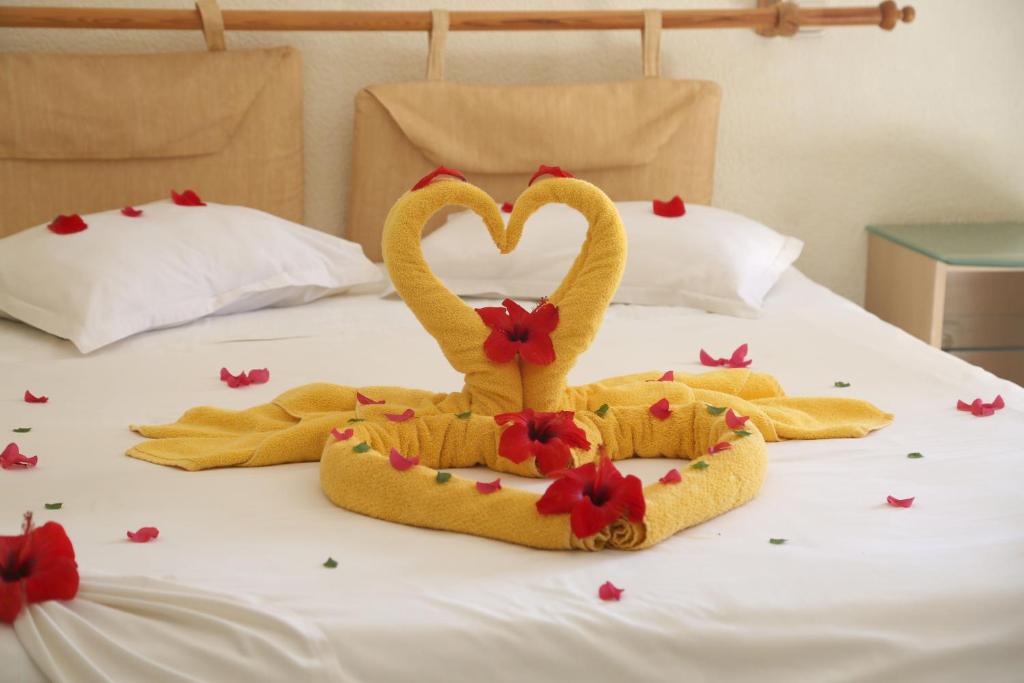 a couple of towelsrendered to look like swans on a bed at Eden Star Resort in Zarzis