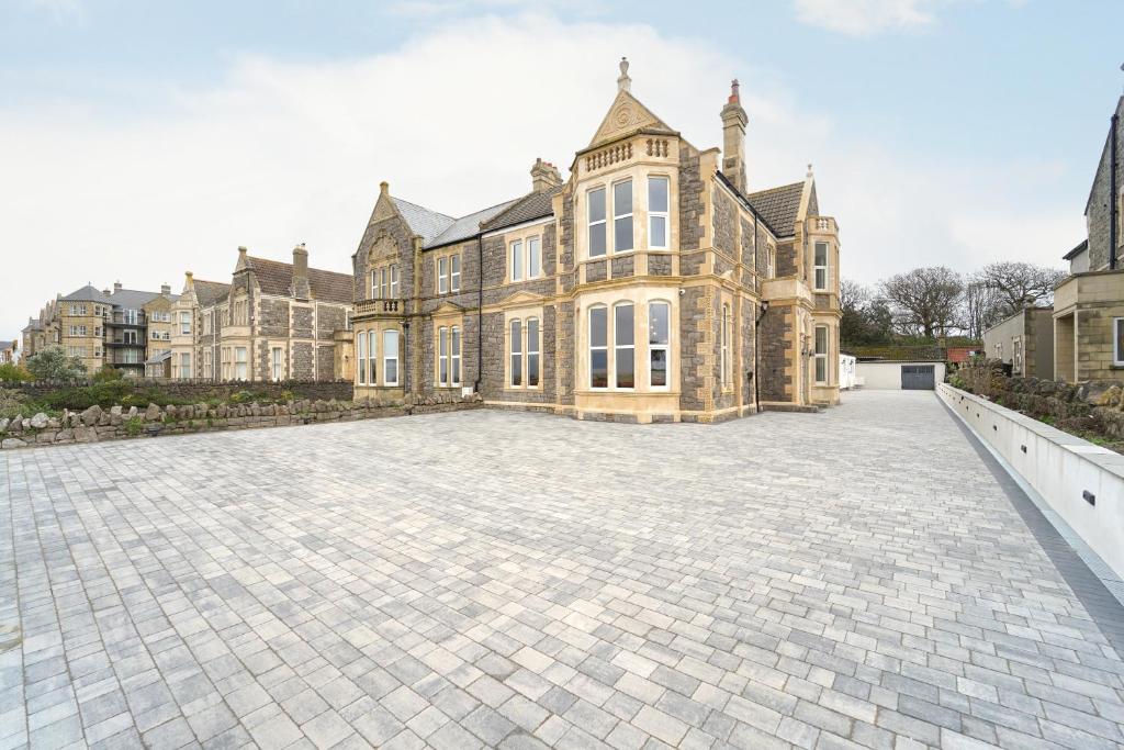 a large brick driveway in front of a large house at Beach Condos in Weston-super-Mare