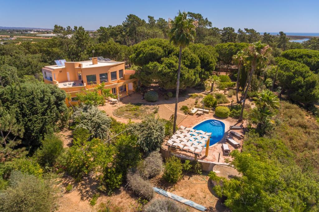 an aerial view of a house with a swimming pool at Meia Lua - Deluxe countryside villa with pool and sea views near Barril beach, Tavira in Luz de Tavira