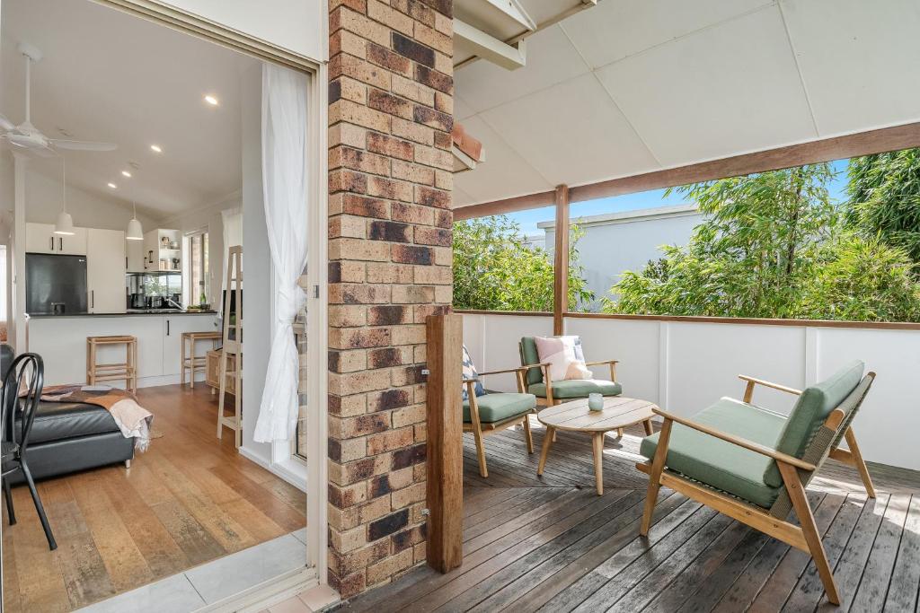 an open living room with a brick wall at Lennox Beach Oasis 3 Bedrooms in town in Lennox Head