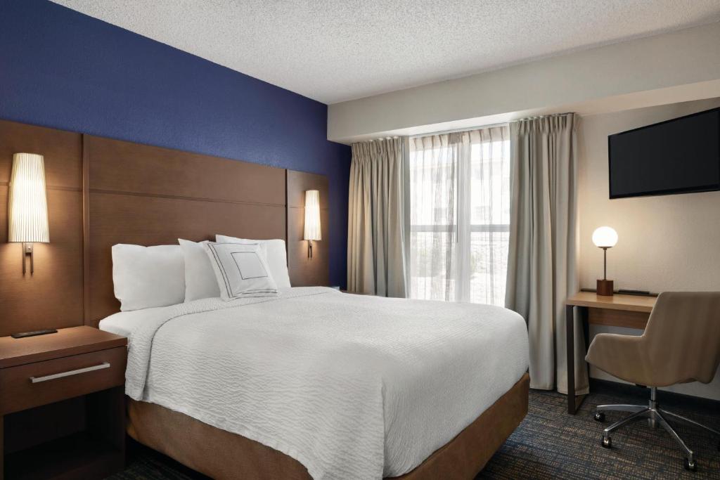 a hotel room with a large bed and a desk at Residence Inn El Paso in El Paso