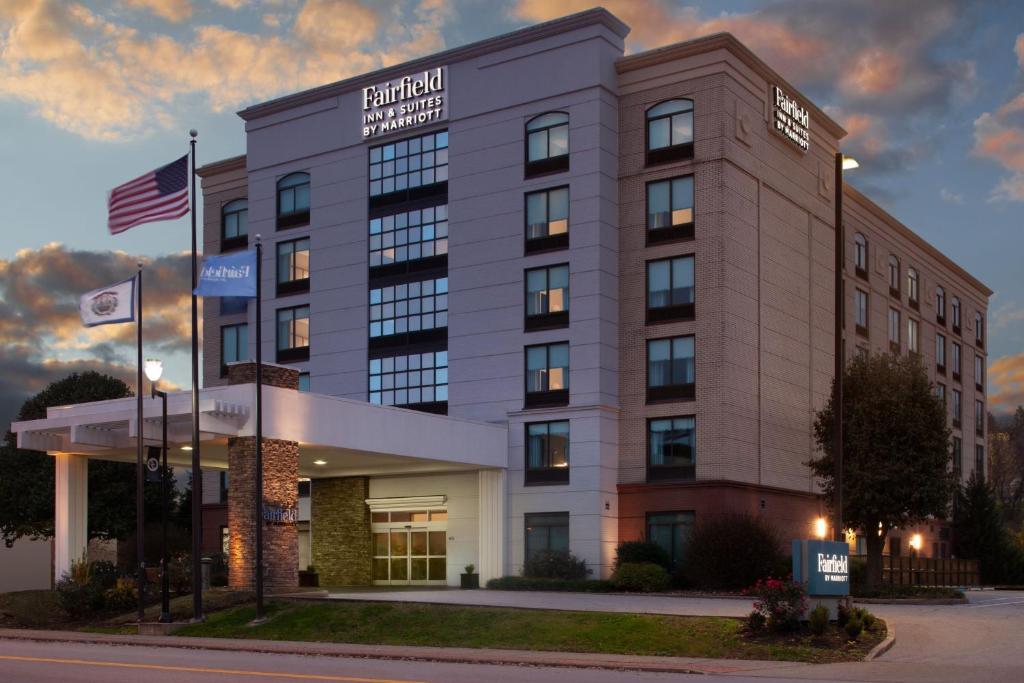 a hotel building with an american flag in front of it at Fairfield Inn & Suites by Marriott Charleston in Charleston
