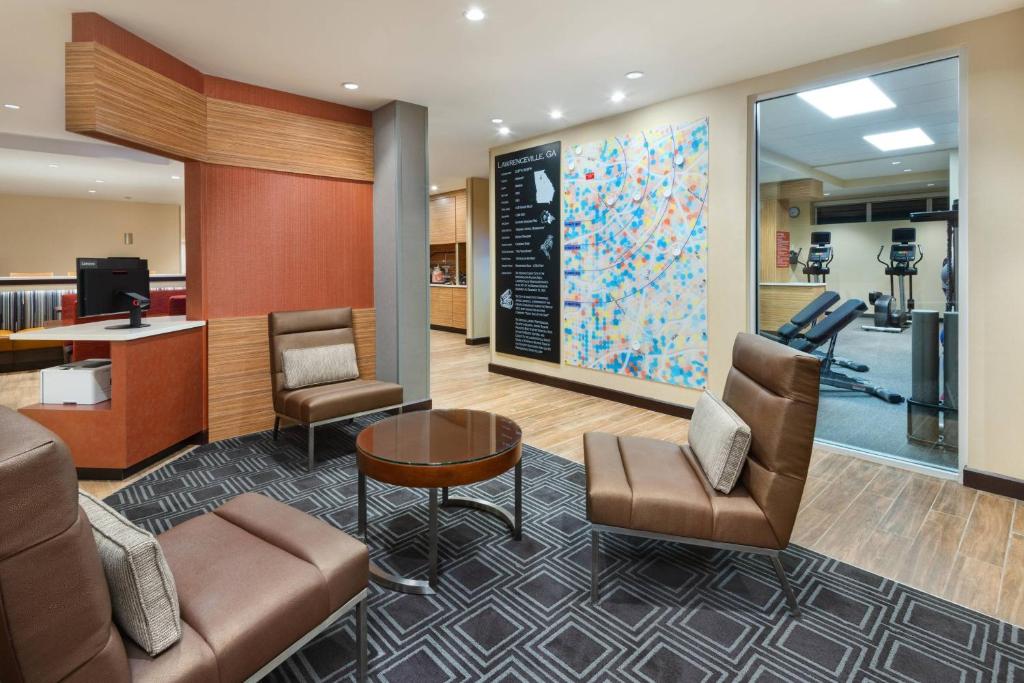 a lobby of a hospital with chairs and a table at TownePlace Suites Atlanta Lawrenceville in Lawrenceville