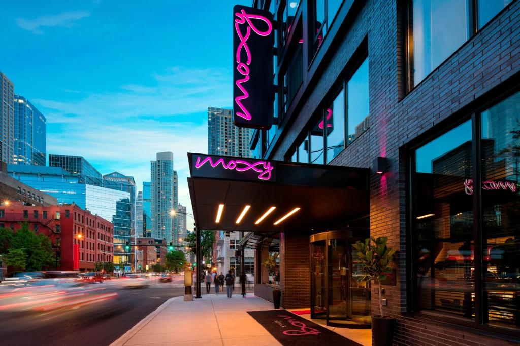 a building with a wacky sign on a city street at Moxy Chicago Downtown in Chicago