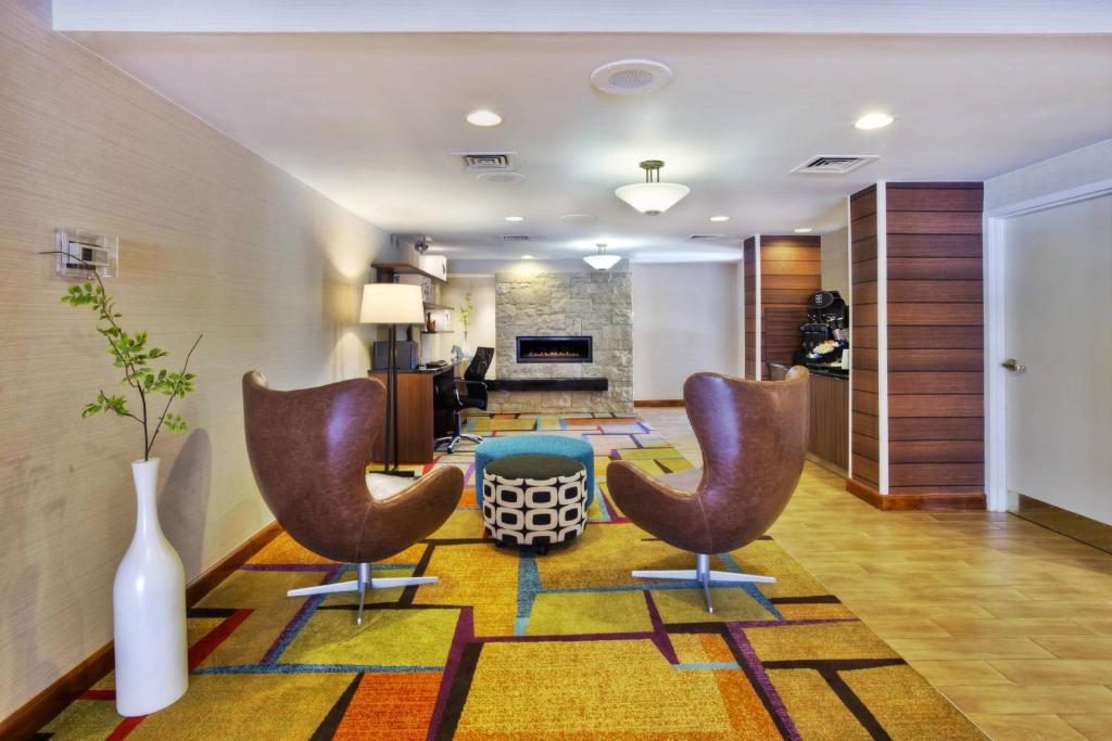 a living room with two chairs and a table at Fairfield Inn Ann Arbor in Ann Arbor